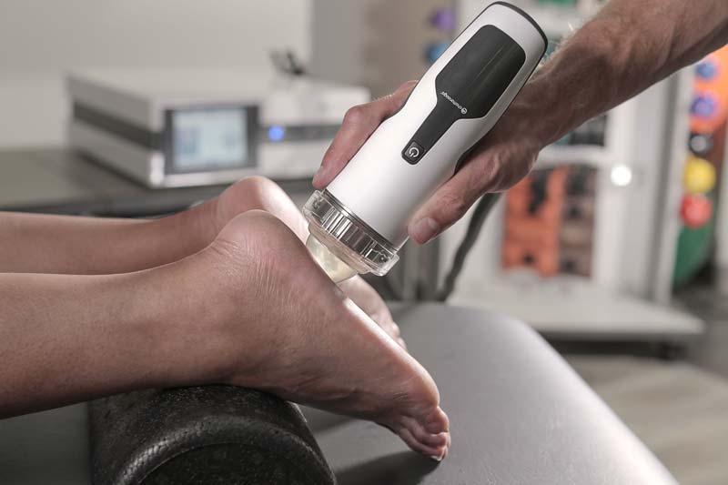 Patient receiving focused shockwave therapy on foot