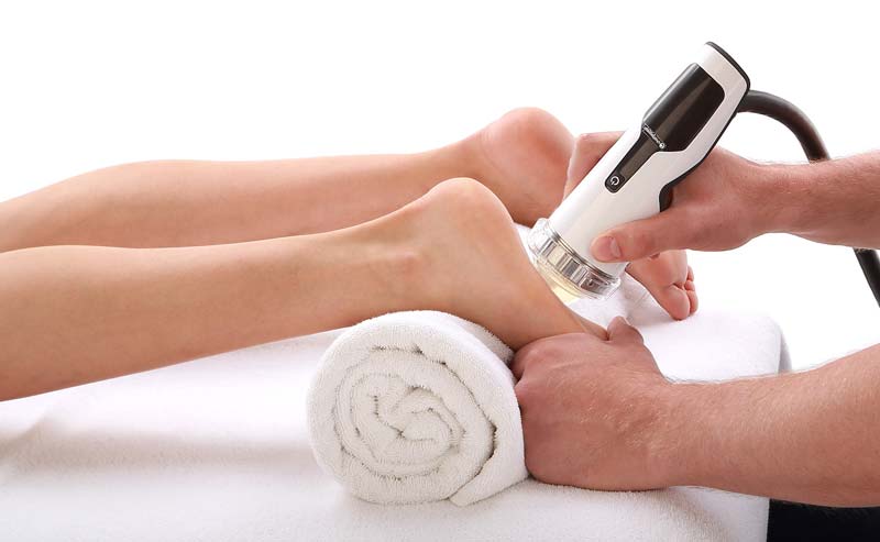Focused shockwave handpiece treating the heel